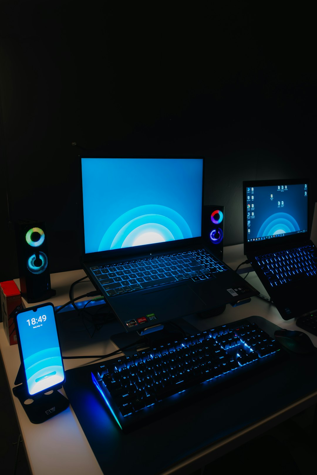 a-desk-with-a-laptop-monitor-keyboard-and-cell-phone-on-it-sglfu5kvne